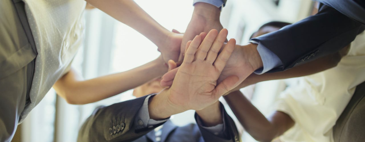 Four people stacking hands 